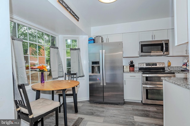 1720 Albermarle Dr Unit 24, Crofton, MD 21114 - kitchen featuring stainless steel appliances, light stone countertops, light wood-type flooring, and white cabinetry