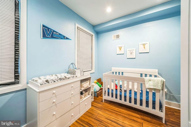 1809 Wilder St, Philadelphia, PA 19146 - bedroom featuring wood finished floors, a nursery area, baseboards, and recessed lighting