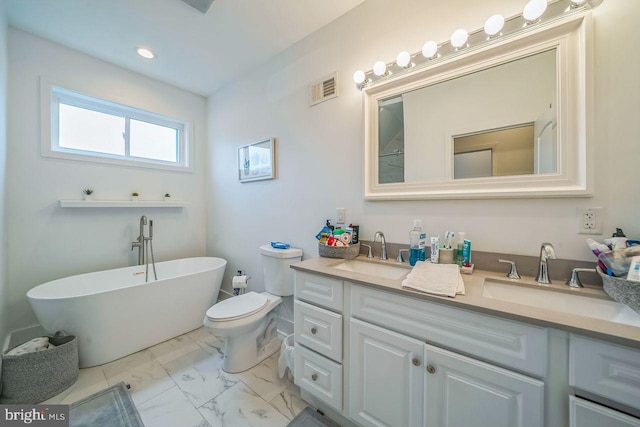 1809 Wilder St, Philadelphia, PA 19146 - full bathroom featuring double vanity, marble look tiles, a freestanding bath, toilet, and recessed lighting