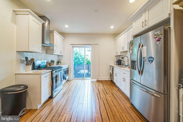 1809 Wilder St, Philadelphia, PA 19146 - kitchen featuring appliances with stainless steel finishes, a sink, light countertops, wall chimney range hood, and decorative backsplash