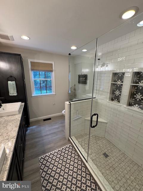 457 Langley Rd, Pittsgrove, NJ 08318 - full bath with baseboards, vanity, a shower stall, wood finished floors, and toilet