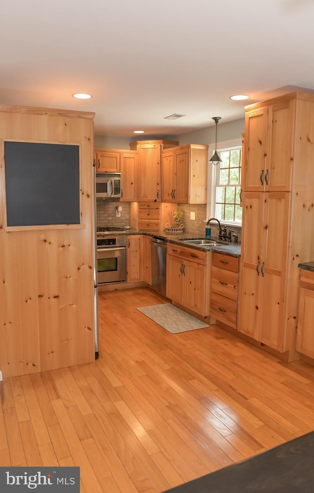 457 Langley Rd, Pittsgrove, NJ 08318 - kitchen featuring stainless steel appliances, a sink, light brown cabinetry, dark countertops, and backsplash