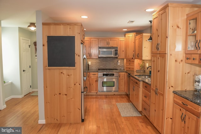 457 Langley Rd, Pittsgrove, NJ 08318 - kitchen with stainless steel appliances, a sink, light wood-style flooring, dark stone countertops, and recessed lighting