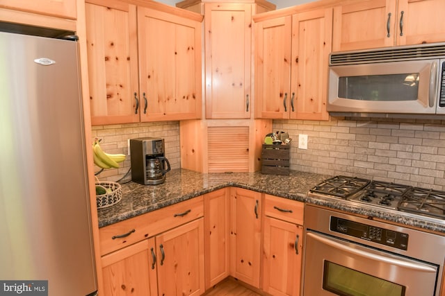 457 Langley Rd, Pittsgrove, NJ 08318 - kitchen with stainless steel appliances, light brown cabinetry, backsplash, and dark stone countertops