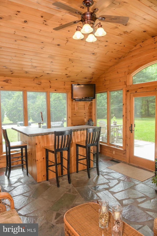 457 Langley Rd, Pittsgrove, NJ 08318 - dining space with stone tile floors, plenty of natural light, vaulted ceiling, ceiling fan, and wooden walls