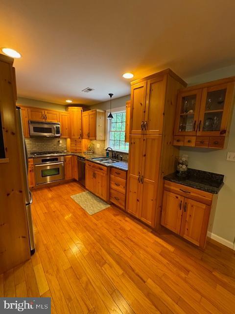457 Langley Rd, Pittsgrove, NJ 08318 - kitchen featuring stainless steel appliances, a sink, brown cabinetry, light wood-type flooring, and recessed lighting