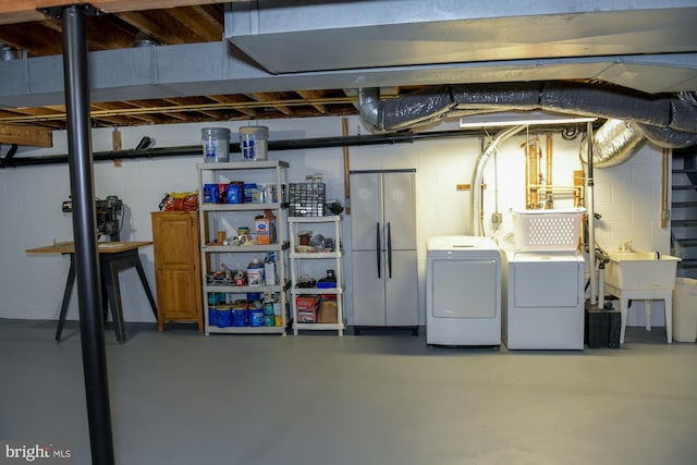 457 Langley Rd, Pittsgrove, NJ 08318 - unfinished below grade area with stainless steel fridge, independent washer and dryer, and concrete block wall