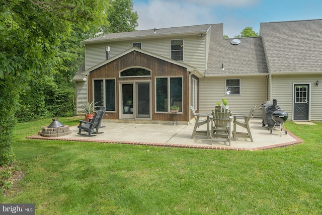 457 Langley Rd, Pittsgrove, NJ 08318 - back of house with an outdoor fire pit, a lawn, a patio area, and roof with shingles