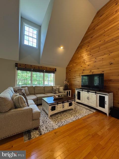 457 Langley Rd, Pittsgrove, NJ 08318 - living area featuring high vaulted ceiling, hardwood / wood-style floors, plenty of natural light, and wood walls