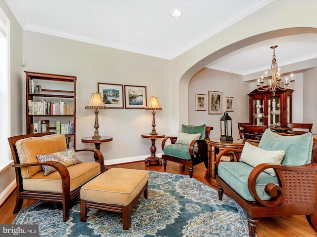 2507 Island Grove Blvd, Frederick, MD 21701 - living area with arched walkways, a chandelier, wood finished floors, baseboards, and crown molding