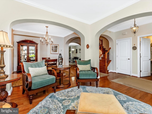 2507 Island Grove Blvd, Frederick, MD 21701 - living area with wood finished floors, arched walkways, ornamental molding, a chandelier, and stairs