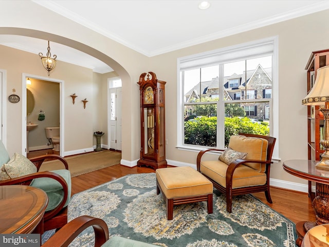2507 Island Grove Blvd, Frederick, MD 21701 - sitting room featuring arched walkways, crown molding, wood finished floors, and baseboards