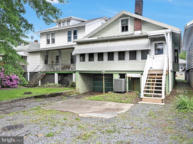 138 W Main St, Schuylkill Haven, PA 17972 - rear view of house with stairway, central AC, a chimney, and covered porch