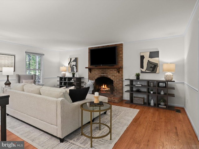7449 Maple Branch Rd, Clifton, VA 20124 - living area featuring a brick fireplace, wood finished floors, ornamental molding, and baseboards
