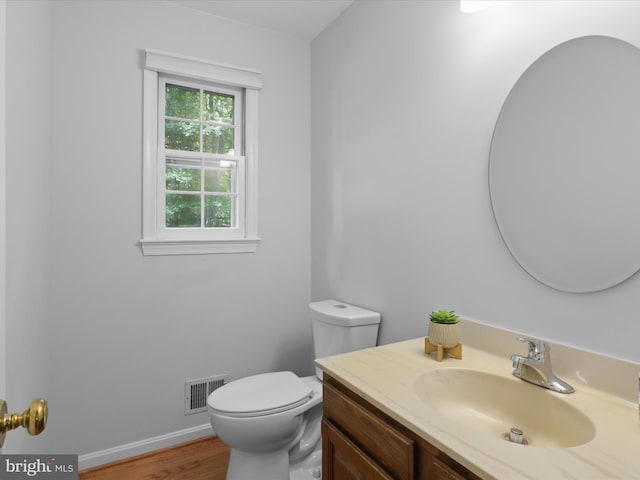 7449 Maple Branch Rd, Clifton, VA 20124 - half bath with vanity, toilet, wood finished floors, and baseboards