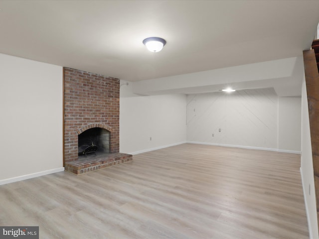 7449 Maple Branch Rd, Clifton, VA 20124 - unfurnished living room featuring light wood-type flooring, baseboards, and a brick fireplace