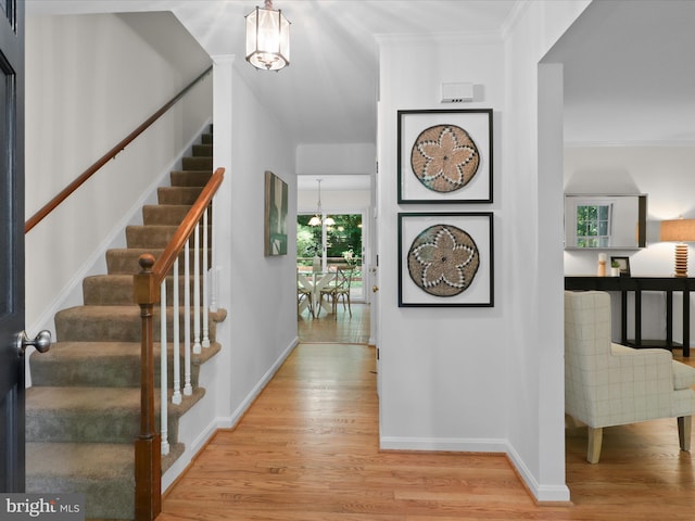 7449 Maple Branch Rd, Clifton, VA 20124 - foyer with a chandelier, wood finished floors, stairs, baseboards, and crown molding