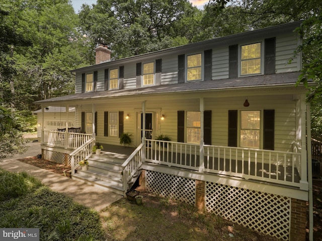 7449 Maple Branch Rd, Clifton, VA 20124 - view of front facade with covered porch, a chimney, and view of scattered trees