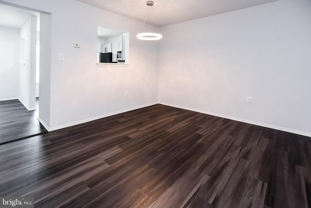 5936 S Hil Mar Cir, District Heights, MD 20747 - empty room featuring baseboards and dark wood-style floors