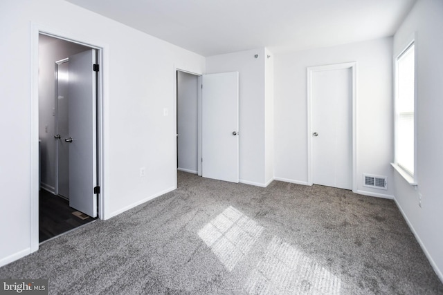 5936 S Hil Mar Cir, District Heights, MD 20747 - unfurnished bedroom featuring carpet floors, multiple windows, and baseboards