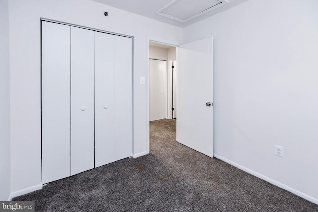 5936 S Hil Mar Cir, District Heights, MD 20747 - unfurnished bedroom featuring dark carpet, a closet, and baseboards