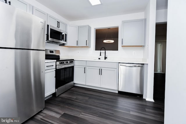5936 S Hil Mar Cir, District Heights, MD 20747 - kitchen featuring appliances with stainless steel finishes, a sink, light countertops, and dark wood finished floors