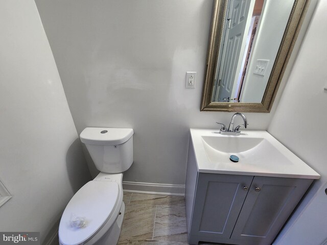 2218 Ruskin Ave, Baltimore, MD 21217 - half bath with toilet, vanity, marble finish floors, and baseboards