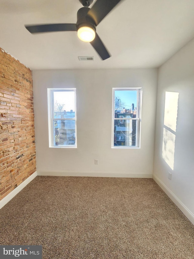 2218 Ruskin Ave, Baltimore, MD 21217 - carpeted empty room with ceiling fan, baseboards, and brick wall
