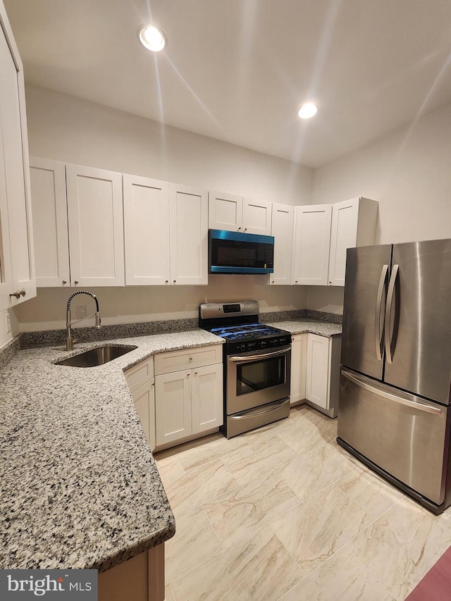 2218 Ruskin Ave, Baltimore, MD 21217 - kitchen with stainless steel appliances, a sink, light stone countertops, and recessed lighting