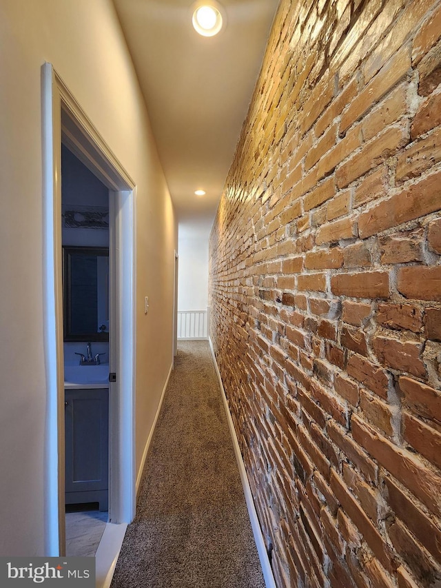 2218 Ruskin Ave, Baltimore, MD 21217 - hall with carpet, a sink, and brick wall