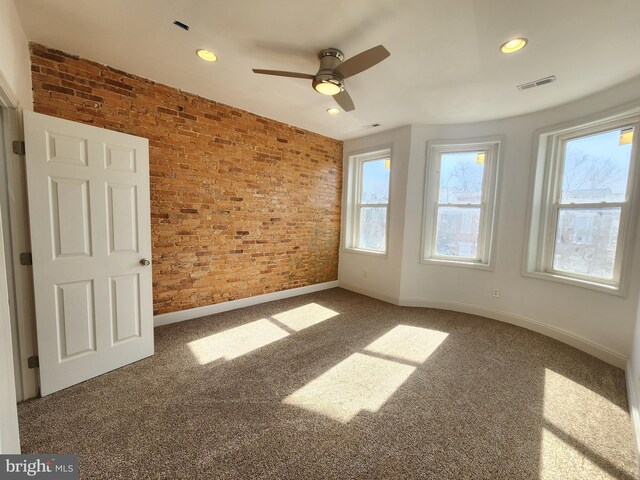 2218 Ruskin Ave, Baltimore, MD 21217 - carpeted empty room featuring brick wall, baseboards, healthy amount of natural light, ceiling fan, and recessed lighting