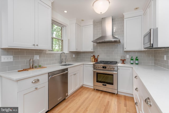 3709 Jocelyn St NW, Washington, DC 20015 - kitchen featuring stainless steel appliances, wall chimney range hood, a sink, white cabinetry, and recessed lighting
