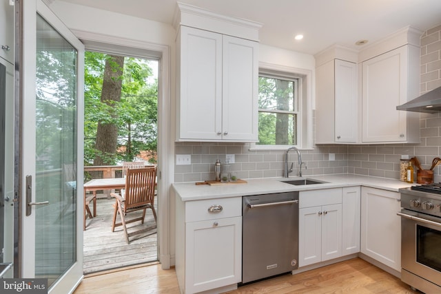 3709 Jocelyn St NW, Washington, DC 20015 - kitchen featuring appliances with stainless steel finishes, a sink, light countertops, backsplash, and white cabinetry