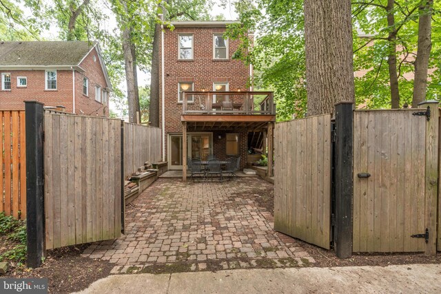 3709 Jocelyn St NW, Washington, DC 20015 - rear view of property with brick siding, a fenced backyard, and a patio area