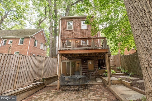 3709 Jocelyn St NW, Washington, DC 20015 - rear view of house featuring brick siding, a patio, a fenced backyard, and outdoor dining space