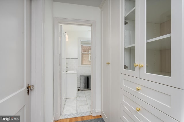3709 Jocelyn St NW, Washington, DC 20015 - hall with radiator heating unit and light marble finish flooring