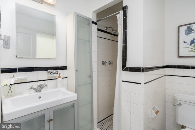 3709 Jocelyn St NW, Washington, DC 20015 - bathroom with tile walls, a shower stall, toilet, vanity, and wainscoting