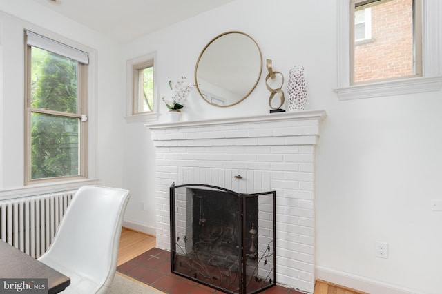 3709 Jocelyn St NW, Washington, DC 20015 - detailed view of radiator, a fireplace, wood finished floors, and baseboards