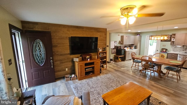 1300 River Rd, Holtwood, PA 17532 - living area with a ceiling fan, wood walls, light wood finished floors, and an accent wall