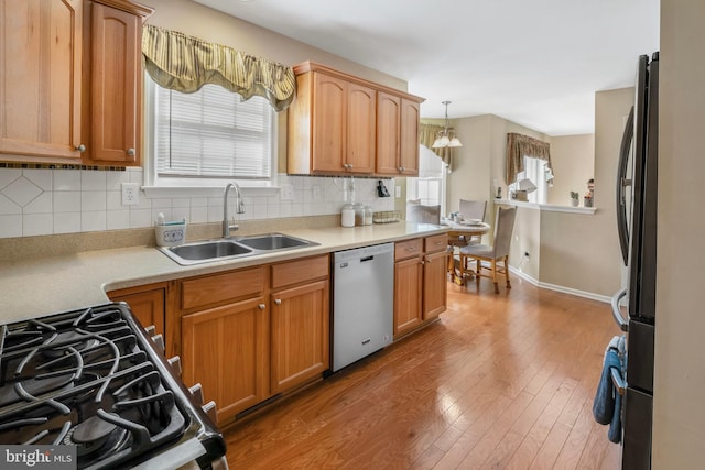 1219 N Valley Ave, Vineland, NJ 08360 - kitchen featuring stainless steel appliances, a sink, wood finished floors, tasteful backsplash, and light countertops