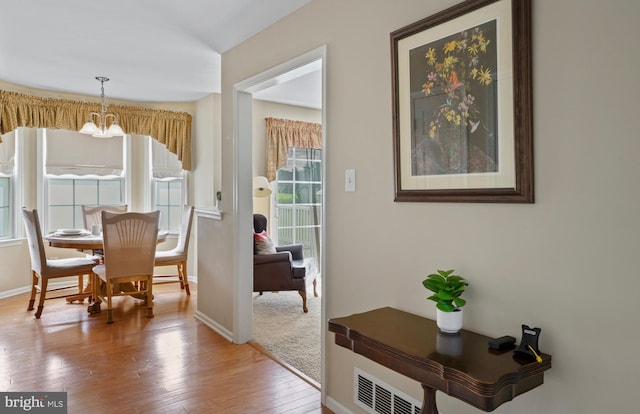 1219 N Valley Ave, Vineland, NJ 08360 - dining area featuring a chandelier, wood finished floors, and baseboards