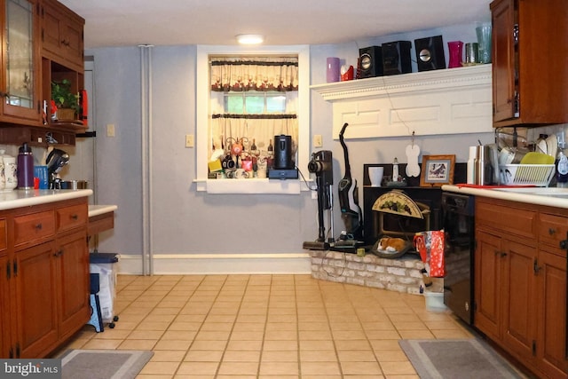229 Valleybrook Rd, Chester Heights, PA 19017 - kitchen with light countertops, brown cabinetry, dishwasher, light tile patterned floors, and baseboards