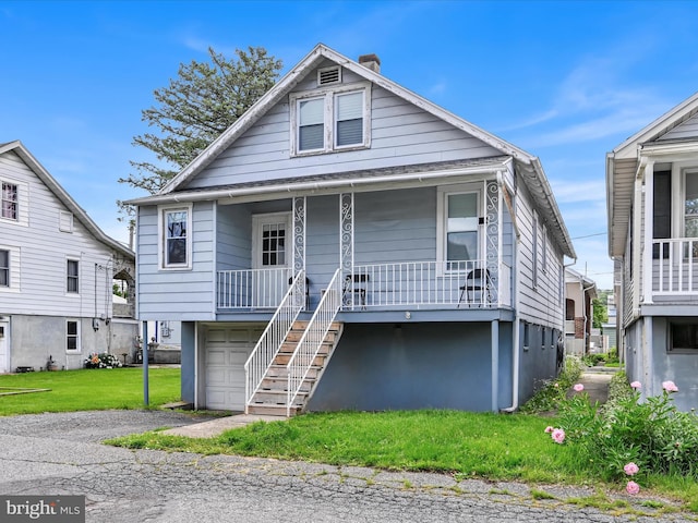 135 Hoover St, Schuylkill Haven, PA 17972 - view of front of property with a porch, a chimney, stairs, asphalt driveway, and a front lawn