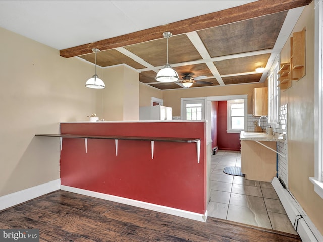 135 Hoover St, Schuylkill Haven, PA 17972 - kitchen featuring a sink, baseboards, a ceiling fan, coffered ceiling, and a baseboard radiator