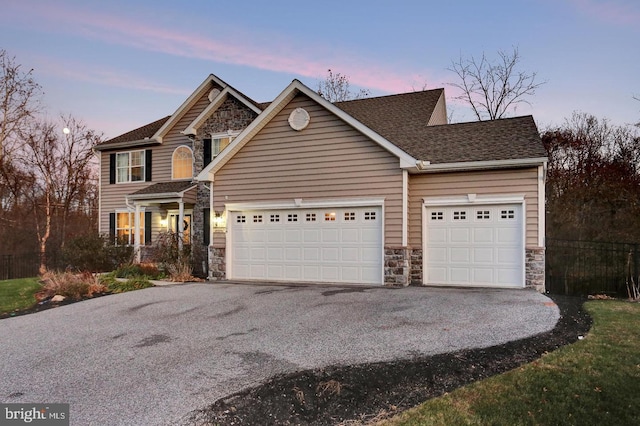 1104 Countryside Dr, Harrisburg, PA 17110 - view of front of property featuring stone siding, an attached garage, asphalt driveway, and roof with shingles