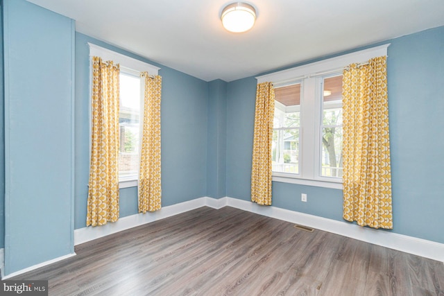 3327 Richmond Ave, Baltimore, MD 21213 - empty room featuring plenty of natural light, wood finished floors, and baseboards