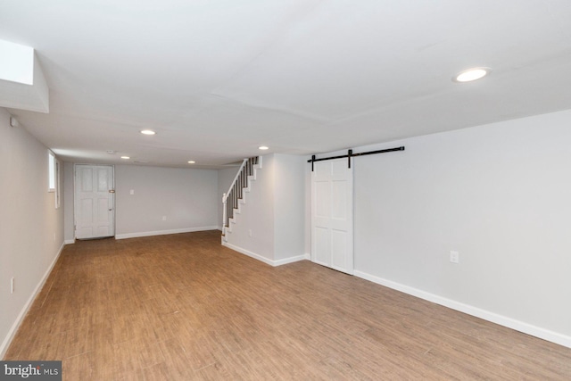 3327 Richmond Ave, Baltimore, MD 21213 - finished below grade area featuring recessed lighting, a barn door, baseboards, light wood-type flooring, and stairs