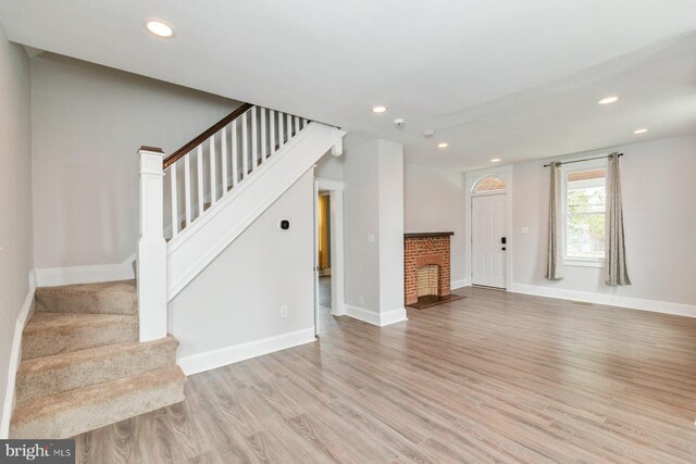 3327 Richmond Ave, Baltimore, MD 21213 - unfurnished living room with light wood-style flooring, stairway, recessed lighting, and baseboards