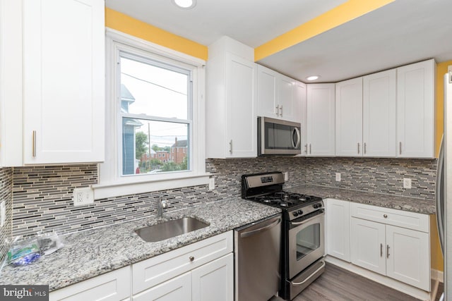 3327 Richmond Ave, Baltimore, MD 21213 - kitchen featuring appliances with stainless steel finishes, a sink, white cabinetry, tasteful backsplash, and recessed lighting