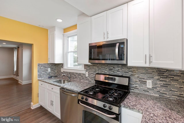 3327 Richmond Ave, Baltimore, MD 21213 - kitchen with stainless steel appliances, a sink, dark wood-type flooring, baseboards, and white cabinetry